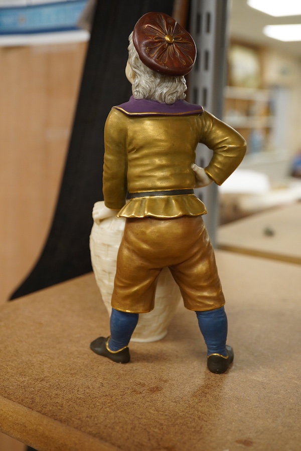 A late 19th century Royal Worcester figure of a boy with basket, 17.5cm high